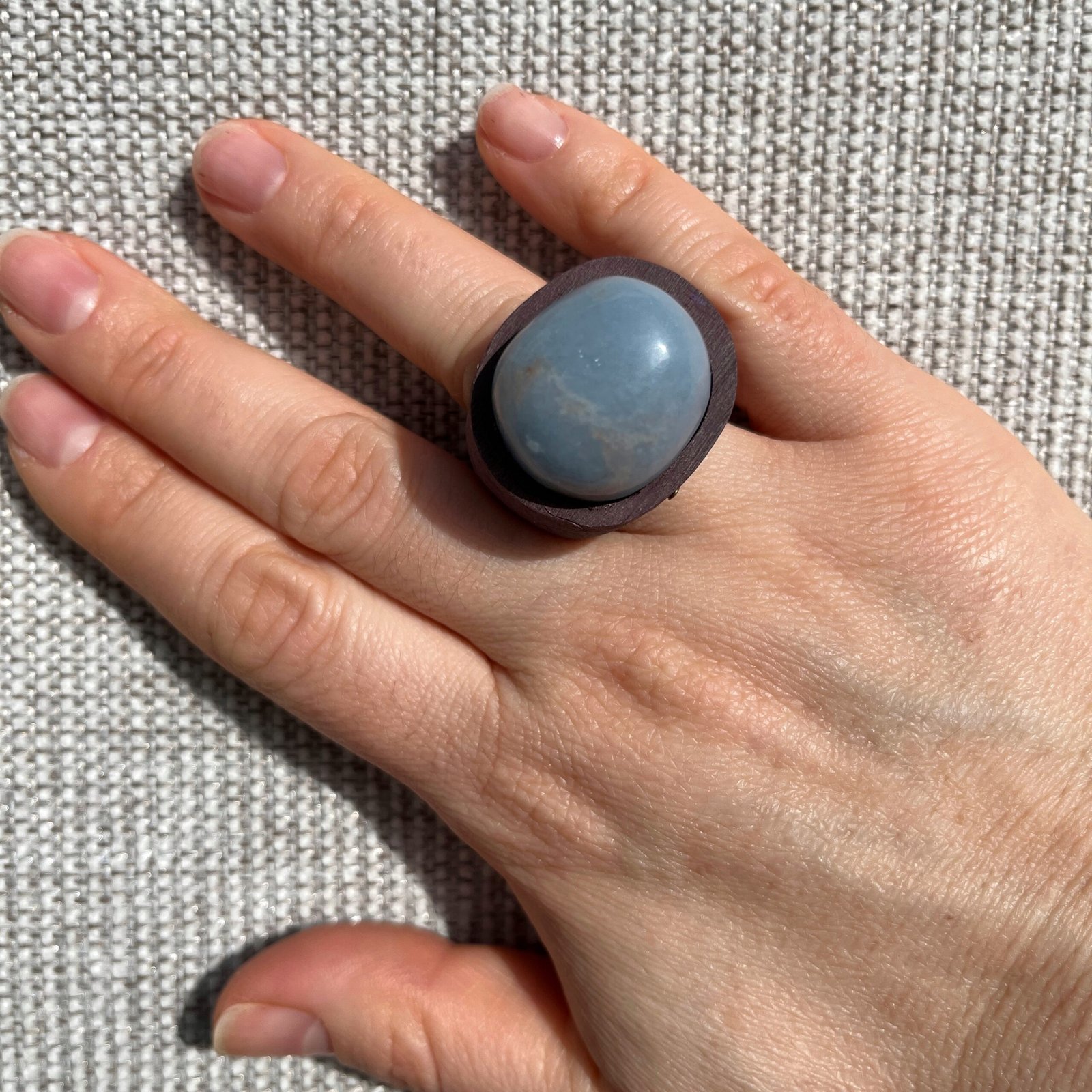 ring-with-natural-stone-angelite-on-hand