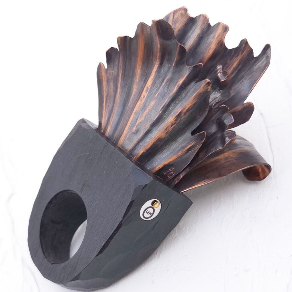 Black clay statement ring with copper petals