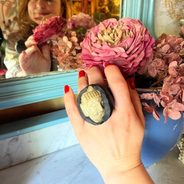 sculptural ceramic ring with travertine buddha on hand