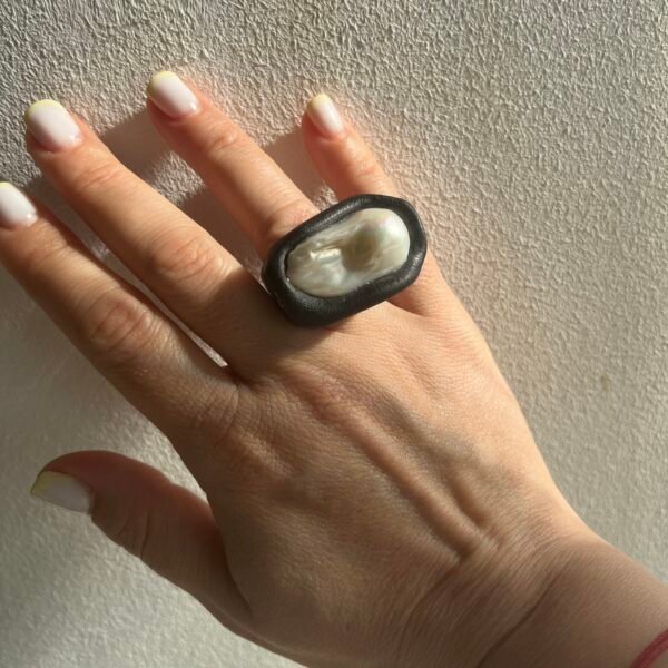Moonlight Embrace statement ring with large white baroque pearl worn on hand, showing size and luster