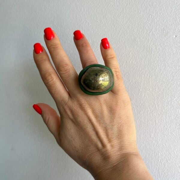 Handmade pyrite statement ring in dark green ceramic worn on hand