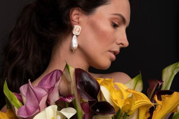 Bride wearing Romeo & Juliet large baroque pearl earrings with antique coral cameos